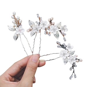 Three-piece set of bridal hair pins with white clay flowers and silver metal leaves