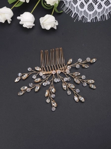 Detail of handcrafted gold wire bridal hair comb with clear crystal beads on black background