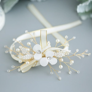 Elegant bridal white floral wrist corsage with pearls and crystals on satin ribbon