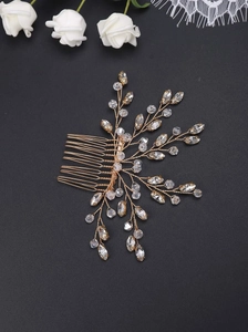 Macro view of handmade gold wire hair comb with crystal beads and rhinestones