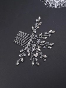 Detailed view of silver bridal hair comb featuring pearls and crystal vine designs