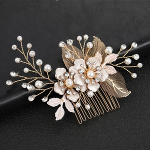 Detail of gold leaf bridal hair comb with sparkling rhinestones and elegant pearls