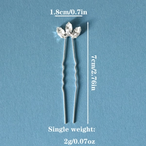Detail view of silver U-shaped hair pins with three marquise rhinestones and wavy metal design