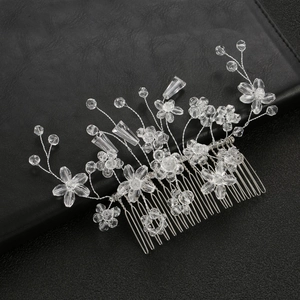 Elegant crystal beaded bridal hair comb with floral design on black leather backdrop