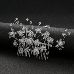 Elegant bridal hair comb with crystal beads and silver floral vine on black stand