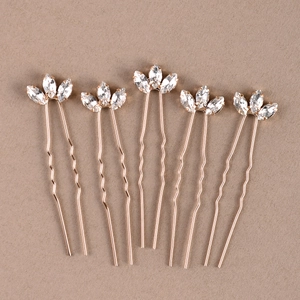 Detailed macro view of 5 rose gold U-shaped hair pins with marquise cut crystals