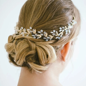 Elegant gold leaf bridal hair vine with white beads for wedding bun hairstyles