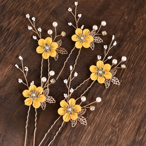 Detailed set of five gold floral hair pins with yellow flowers and white pearls