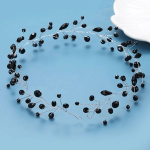 Elegant black crystal bead headband with silver vine wire on a light blue background