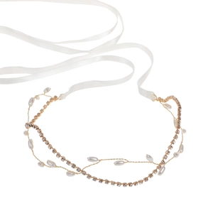 Elegant gold bridal headband featuring white pearls and sparkling crystals with satin ribbons