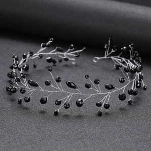 Macro shot of black crystal beads and silver wire twist detail on a handmade headband