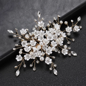 Elegant bridal hair comb with white flowers, pearls and crystals on golden wire