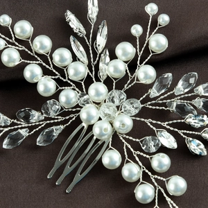 Close-up of handmade emerald crystal and pearl bridal hair comb with silver wire