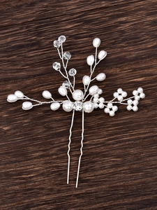 U-shaped bridal hair pin with handmade pearls and crystal beads on a wooden surface