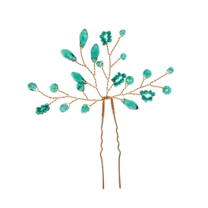 Detail of handmade U-shaped hair pin with emerald green crystals and gold branch wires