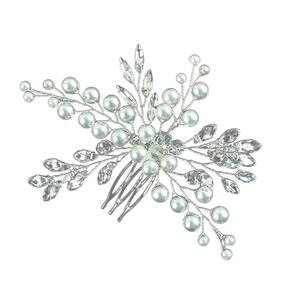 Close-up of bridal hair comb with emerald crystals, pearls and silver wire detail