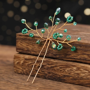 Handmade gold bridal hair pin with emerald green crystals and branch design