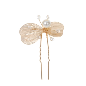 Detail of a hollow gold butterfly hair pin with pearls and crystals for wedding styling