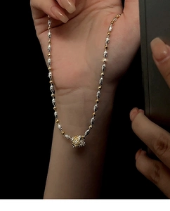 Dettaglio della collana bicolore oro e argento con ciondolo traforato a stella in pizzo