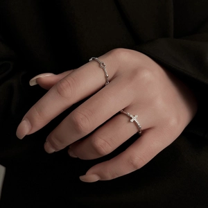 Minimalist silver heart and cross beaded rings set worn for a refined aesthetic look