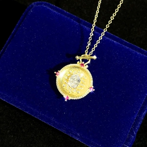 Vintage gold coin pendant necklace with large oval gemstone and red stone accents