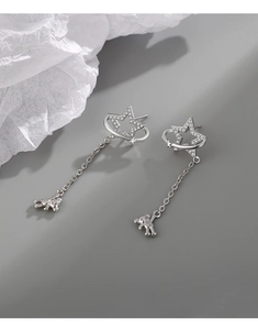 Detailed view of silver star stud earrings featuring a dangling teddy bear charm and zircon