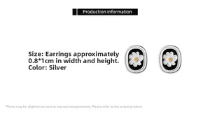 Detail view of small oval daisy earrings with black enamel and silver metal edges