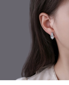 Macro shot of a silver S925 stud earring with Lucky engraving and clear cubic zirconia