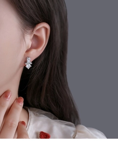Detail view of silver stud earring featuring Lucky engraving and a sparkling zircon stone