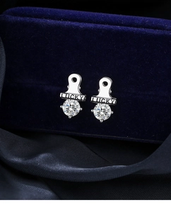 Macro shot of silver clips earrings with LUCKY engraving and cubic zirconia stones