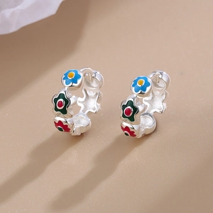 Silver hoop earrings with colorful enamel flowers in red, blue, and green floral design