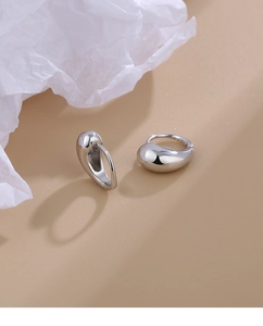 Detailed macro shot of water drop earrings showing S925 hallmark and mirror polish finish