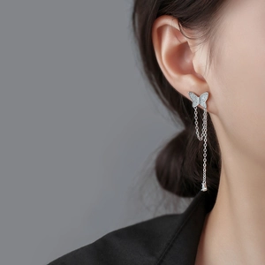 Elegant asymmetric silver butterfly tassel earrings with sparkling crystals and gemstones