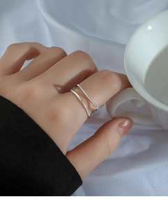 Close-up of minimalist double-layer geometric silver ring worn on female finger