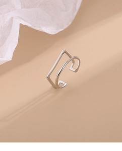 Macro detail of minimalist silver double-layer geometric open ring with polished finish