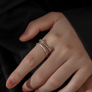Minimalist double-layered rectangular silver open ring shown on a model hand