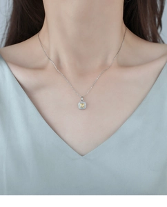 Detail of yellow square crystal pendant necklace worn by a model in elegant style