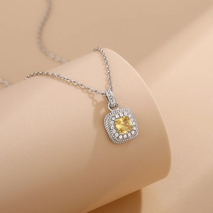 Elegant silver necklace with cushion-cut yellow crystal pendant and rope texture
