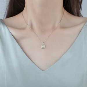 Elegant silver necklace featuring a square yellow crystal pendant with pavé diamond halo