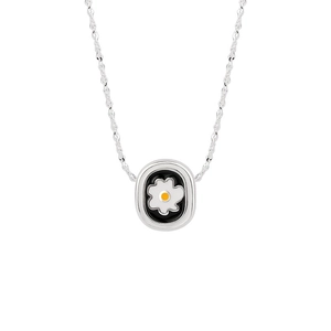Elegant silver daisy necklace with black enamel oval flower pendant on white background