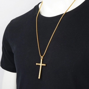 Hiphop gold cross necklace for men with textured cylindrical pattern on black shirt