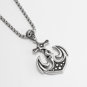 Macro shot of vintage silver anchor skull pendant with punk rock engraving and box chain