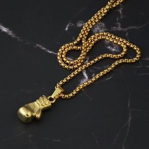 Close-up of polished gold boxing glove pendant on a durable round box chain necklace