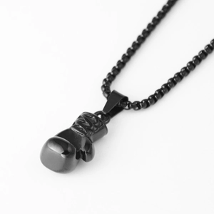 Detailed view of polished black boxing glove pendant on matching bead chain necklace