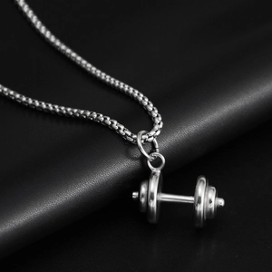Detailed close-up of a silver dumbbell pendant with high-polished stainless steel finish