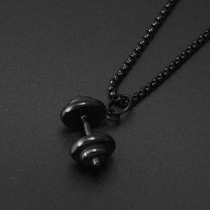 Macro shot of matte black barbell pendant necklace for fitness gym enthusiasts