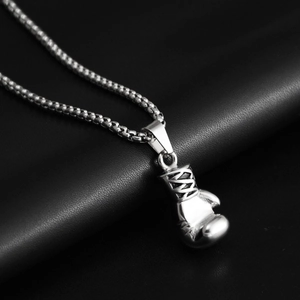 Detailed close-up of a silver boxing glove pendant on a sturdy box chain necklace