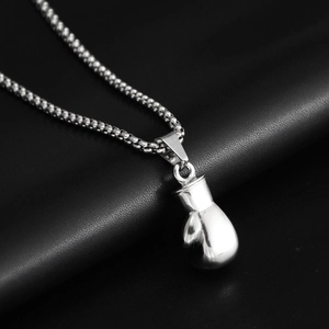 Detailed close-up of a silver boxing glove pendant on a ball chain necklace