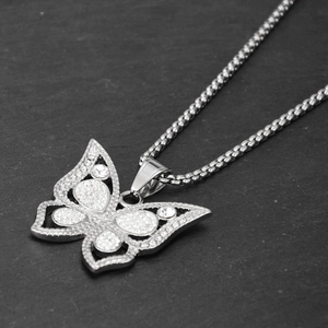 Detailed view of hip hop butterfly pendant with white rhinestones and steel box chain link