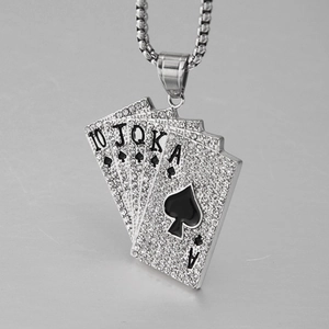 Macro shot of silver hip hop pendant featuring iced-out poker royal flush cards and beads
